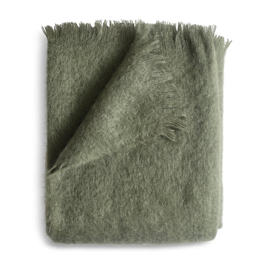 A soft olive green mohair throw blanket with a plush fuzzy texture and fringed edges in moss color