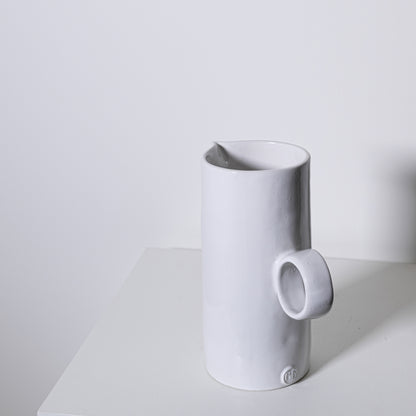 White ceramic fir pitcher no 923 with minimalist design and small circular handle for elegant serving