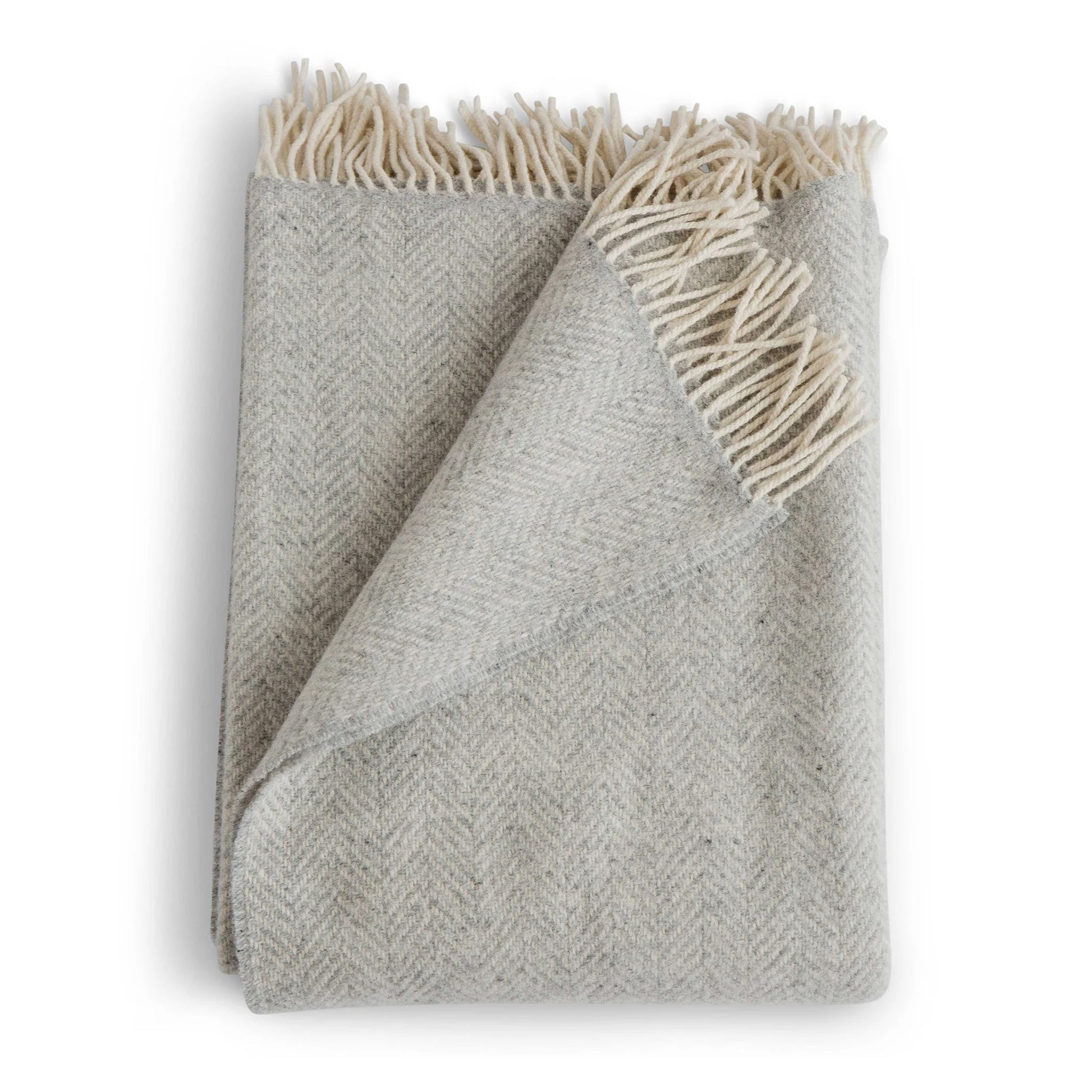 Gray woven blanket with white fringe on a white background