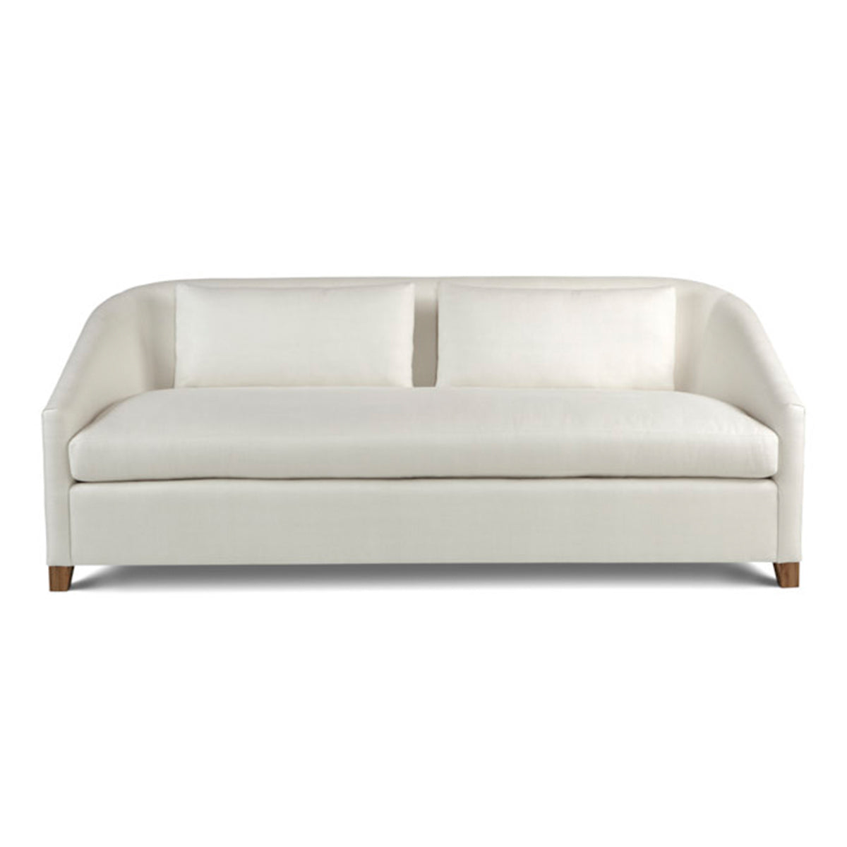 Cream-colored custom order Genevie sofa upholstered with curved arms and wooden legs designed for living rooms