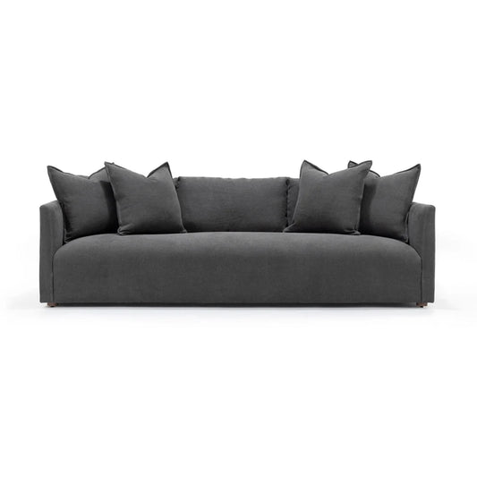 Gray sofa with decorative pillows on a white background