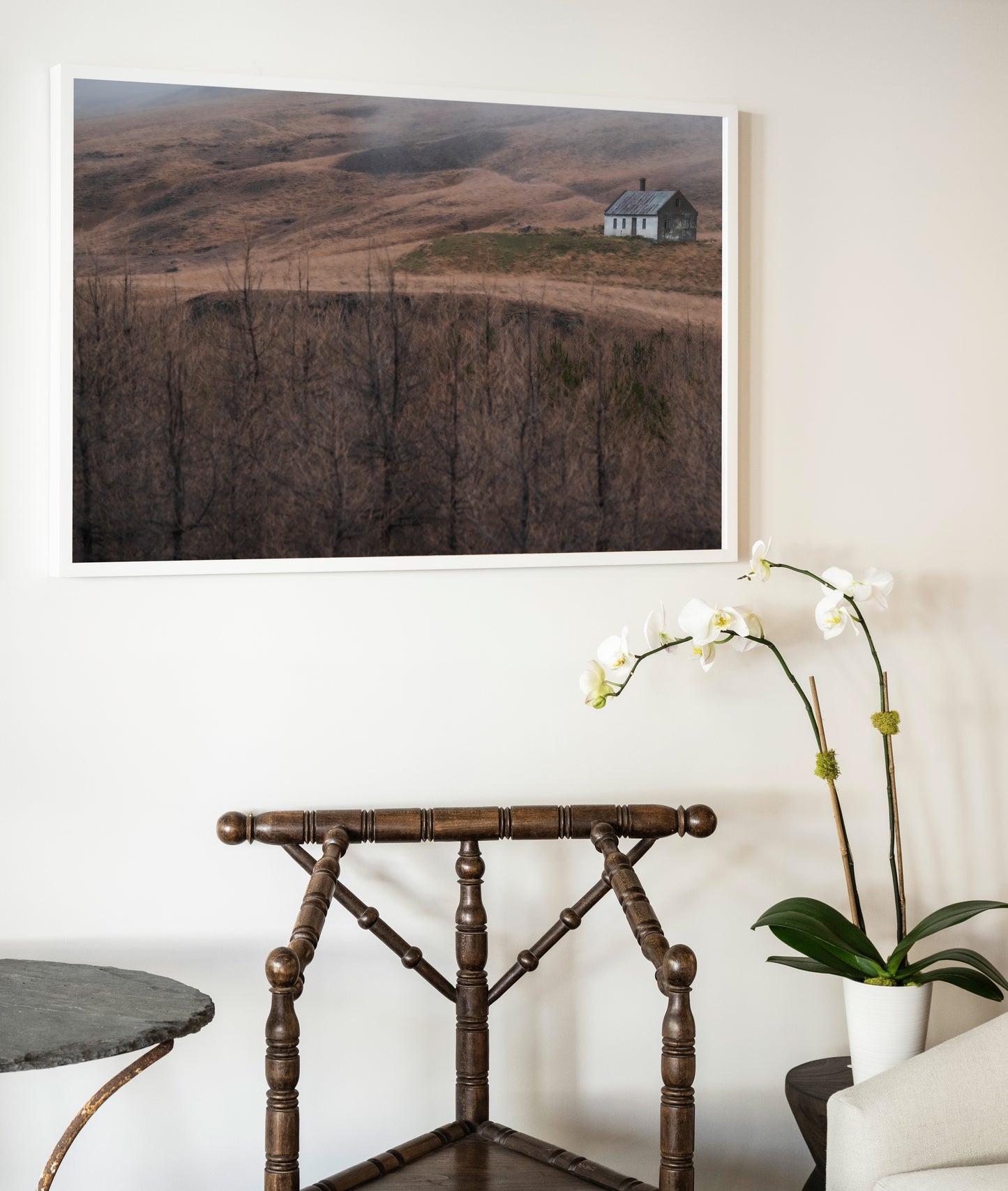 A framed photograph titled house of silence showing a solitary house in a misty brown landscape with bare trees