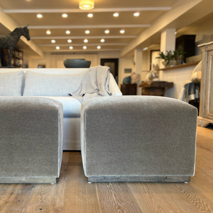 Gray velvet aurora ottomans with metal bases floor model showcasing plush upholstery and sturdy design