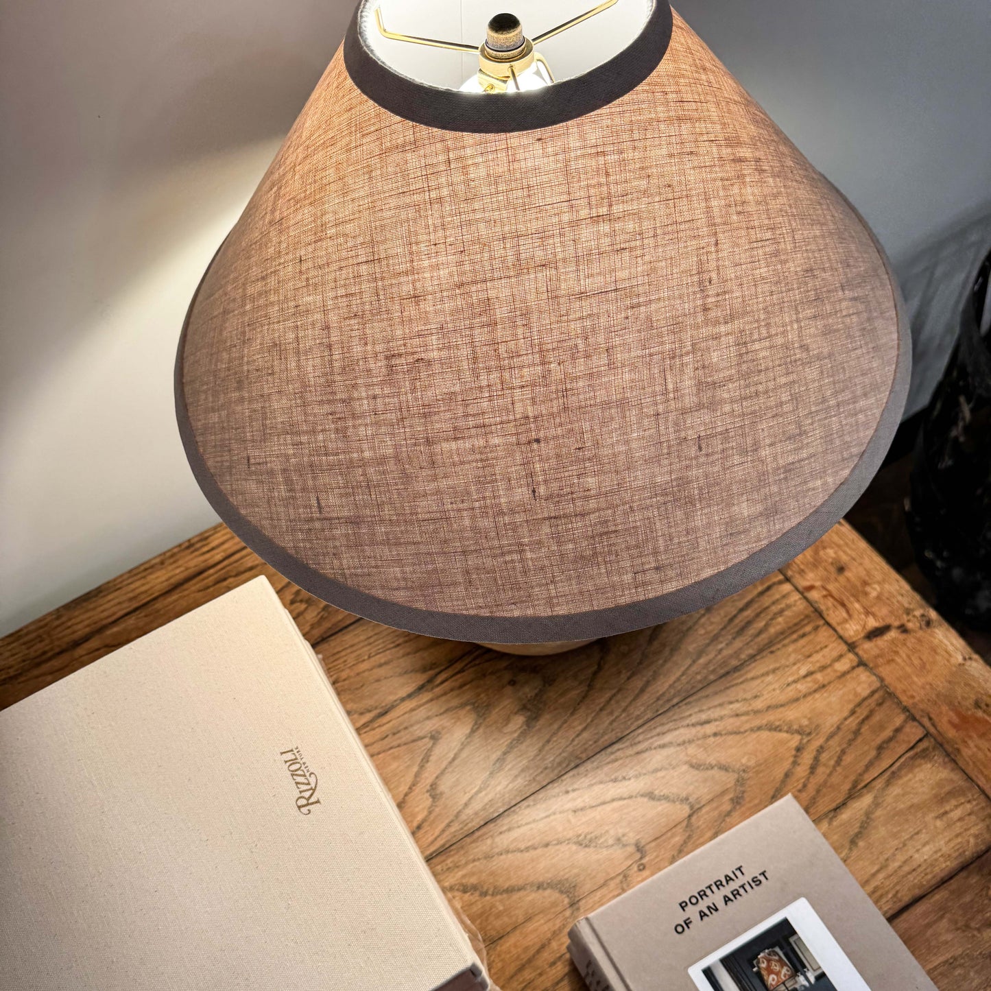 Beige linen lampshade with dark gray trim on mid century Shanxi clay pot table lamp