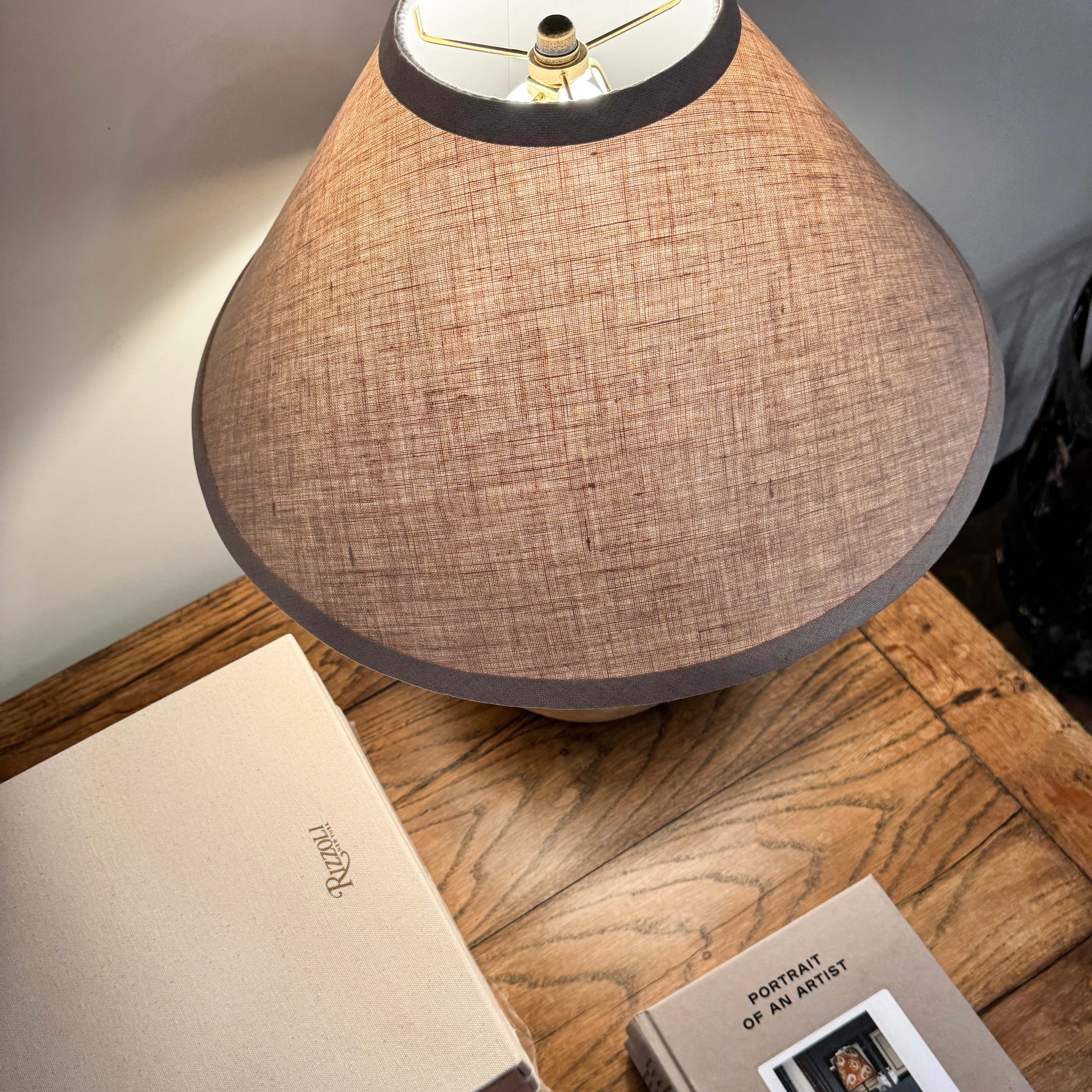 Beige linen lampshade with dark gray trim on mid century Shanxi clay pot table lamp