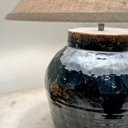 Mid century Shanxi glazed pot table lamp with a dark blue ceramic base textured glazed finish and rustic brown rim