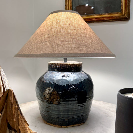 Mid century Shanxi glazed pot table lamp in rustic dark blue ceramic with textured finish and beige linen shade