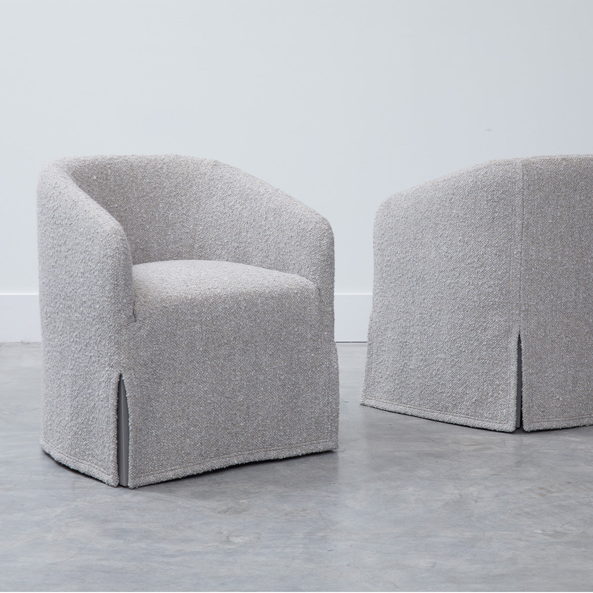 Custom order jolene swivel club chair in gray textured fabric with rounded back and skirted base for comfortable seating