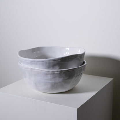 Two stacked magnolia bowl no 228 ceramic bowls with matte textured gray finish and handcrafted edges