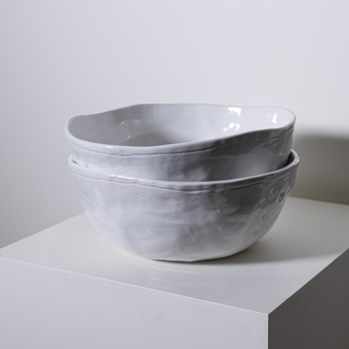 Two stacked magnolia bowl no 228 ceramic bowls with matte textured gray finish and handcrafted irregular edges