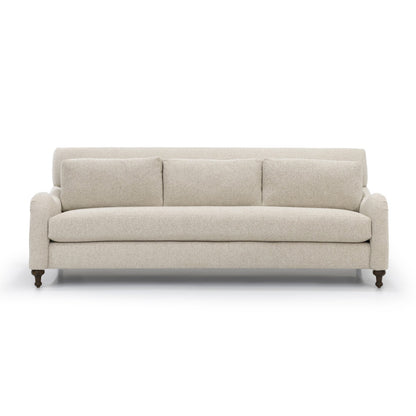 Beige upholstered custom order margot three-seater sofa with rolled arms and dark wooden legs