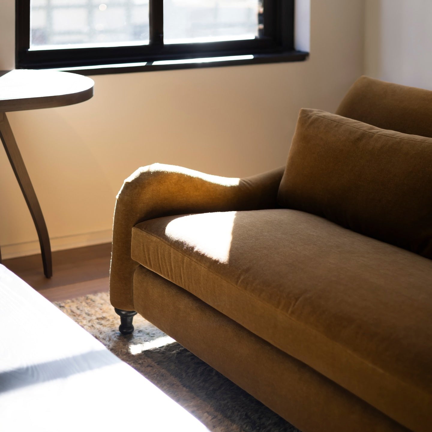 Custom order margot sofa a plush mustard-yellow velvet sofa with rolled arms and dark wooden legs