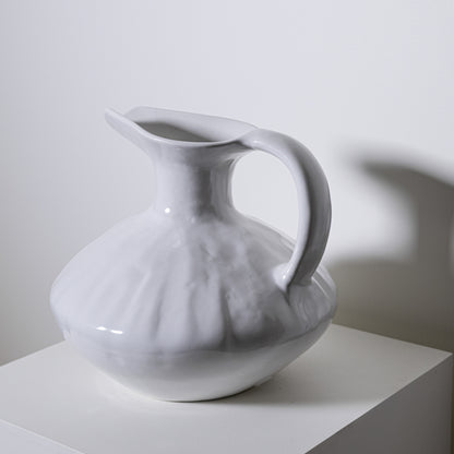 A white ceramic oak pitcher no 431 with a fluted textured body and smooth handle for serving liquids