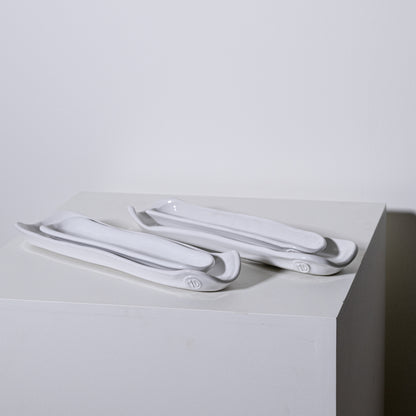 White ceramic olive appetizer plates with sleek modern design and subtle gray accents for serving trays