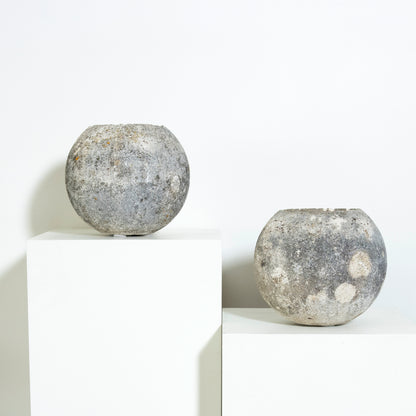 Two spherical concrete objects on a white background