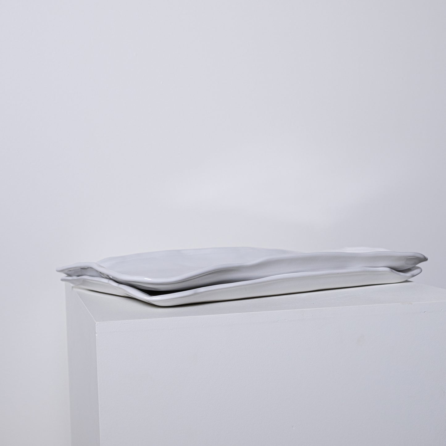 A sleek silver metallic clutch bag ponderosa platter no 226 with minimalist design and soft folds