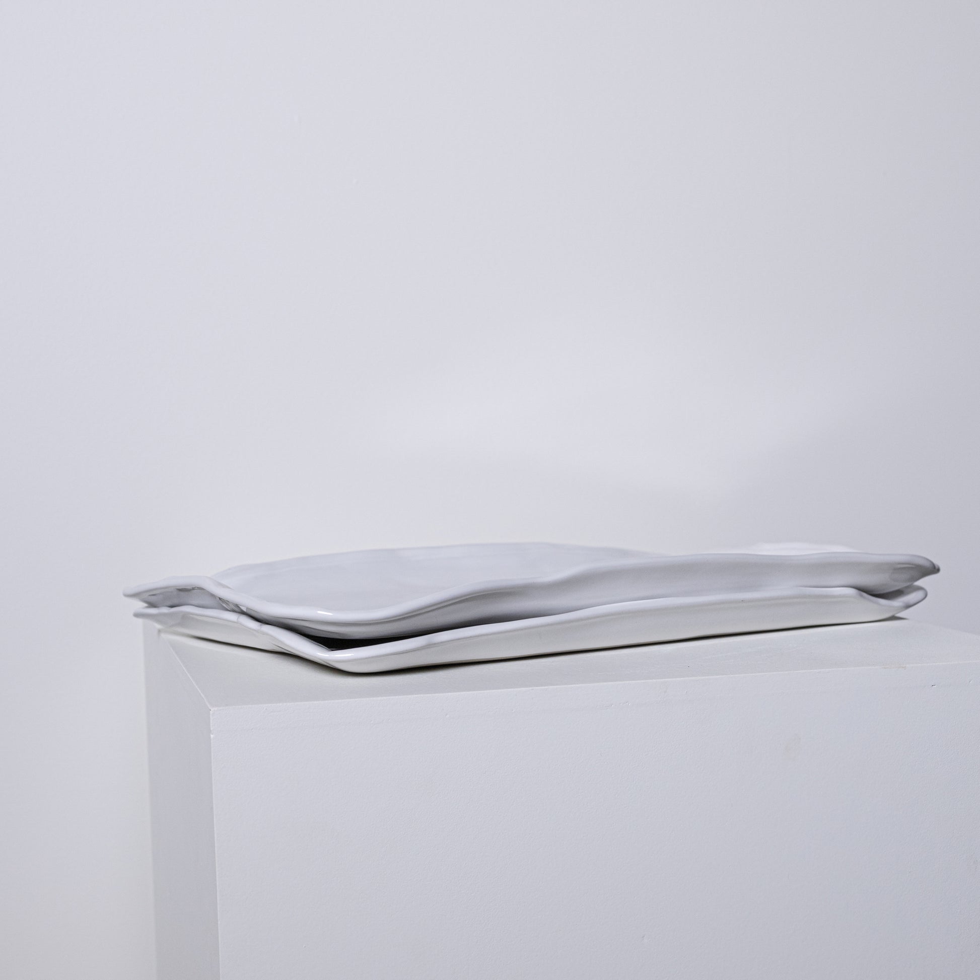 A sleek silver metallic clutch bag ponderosa platter no 226 with minimalist design and soft folds