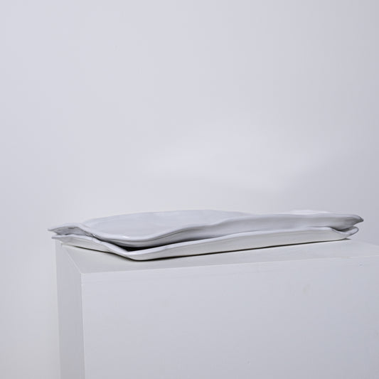 A sleek silver metallic clutch bag ponderosa platter no 226 with minimalist design and soft folds