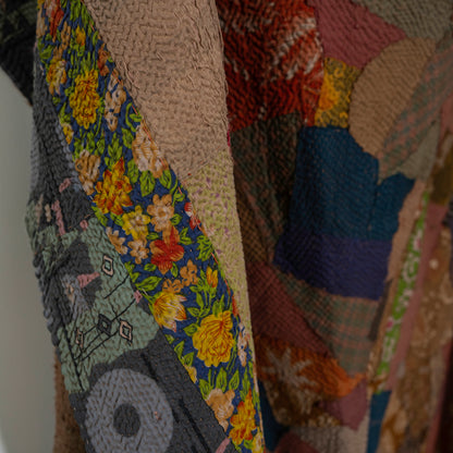 A close-up of a patchwork quilt with multiple fabric panels