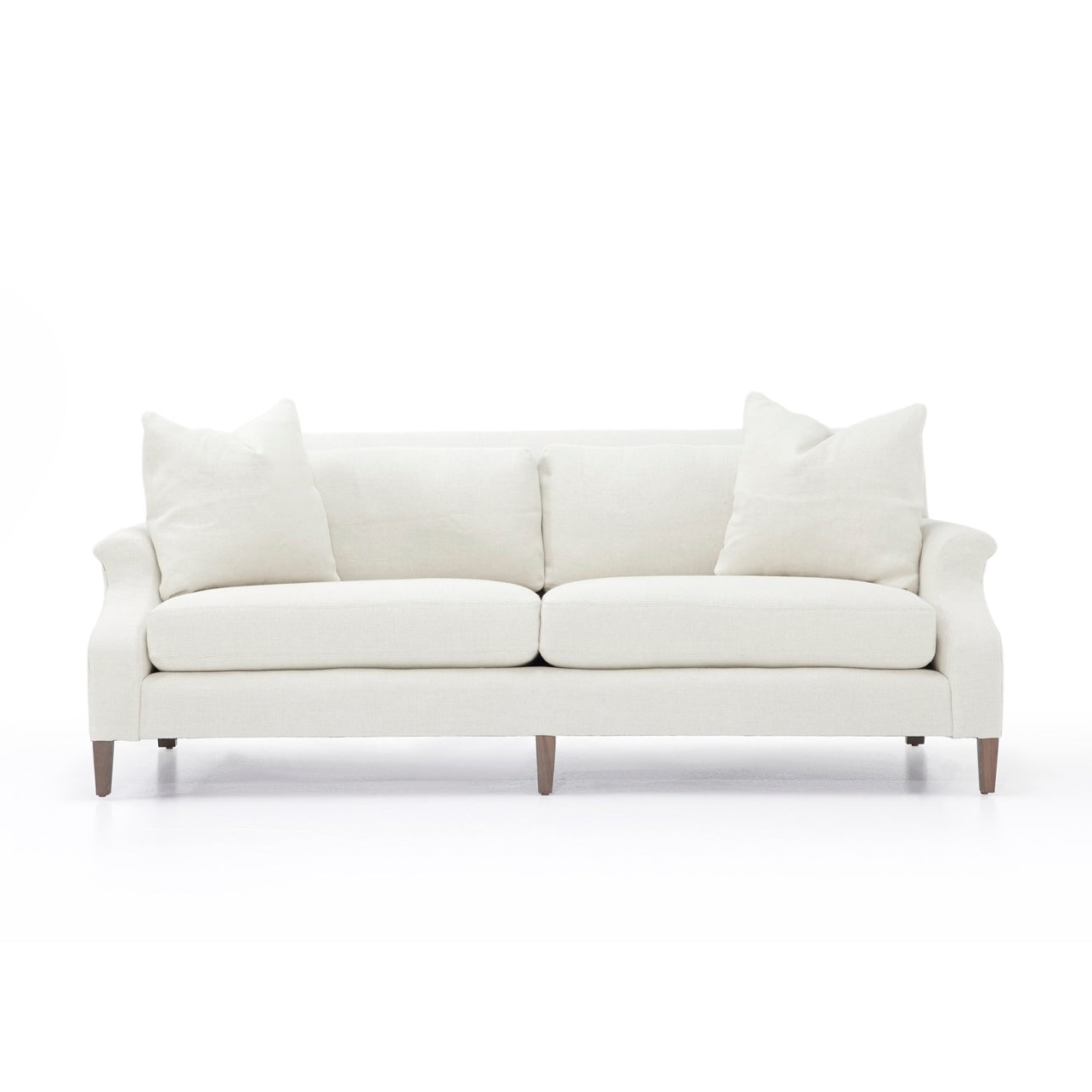 Cream-colored custom order Rafael sofa with rolled arms upholstered in fabric and wooden legs
