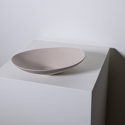 A sleek matte-finished beige ceramic vessel sink with a modern minimalist design baccello small greige