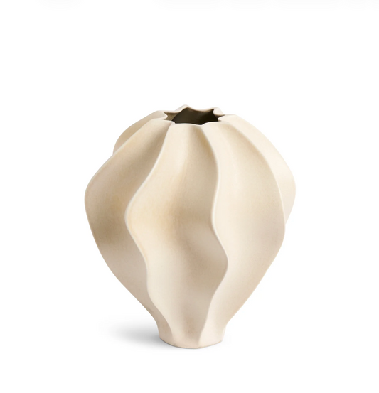 White ceramic vase with a wavy design on a white background