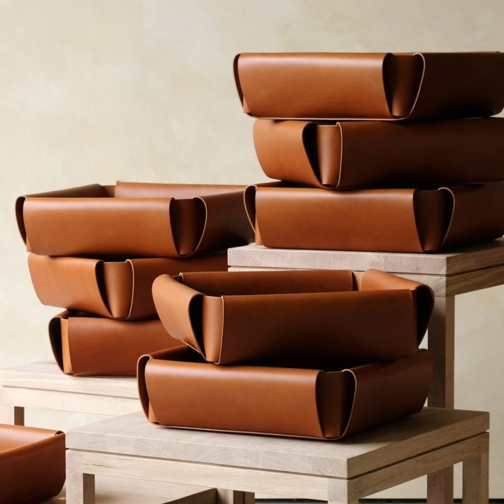 Brown leather assembly basket with sleek minimalist design for organized storage and assembly tasks