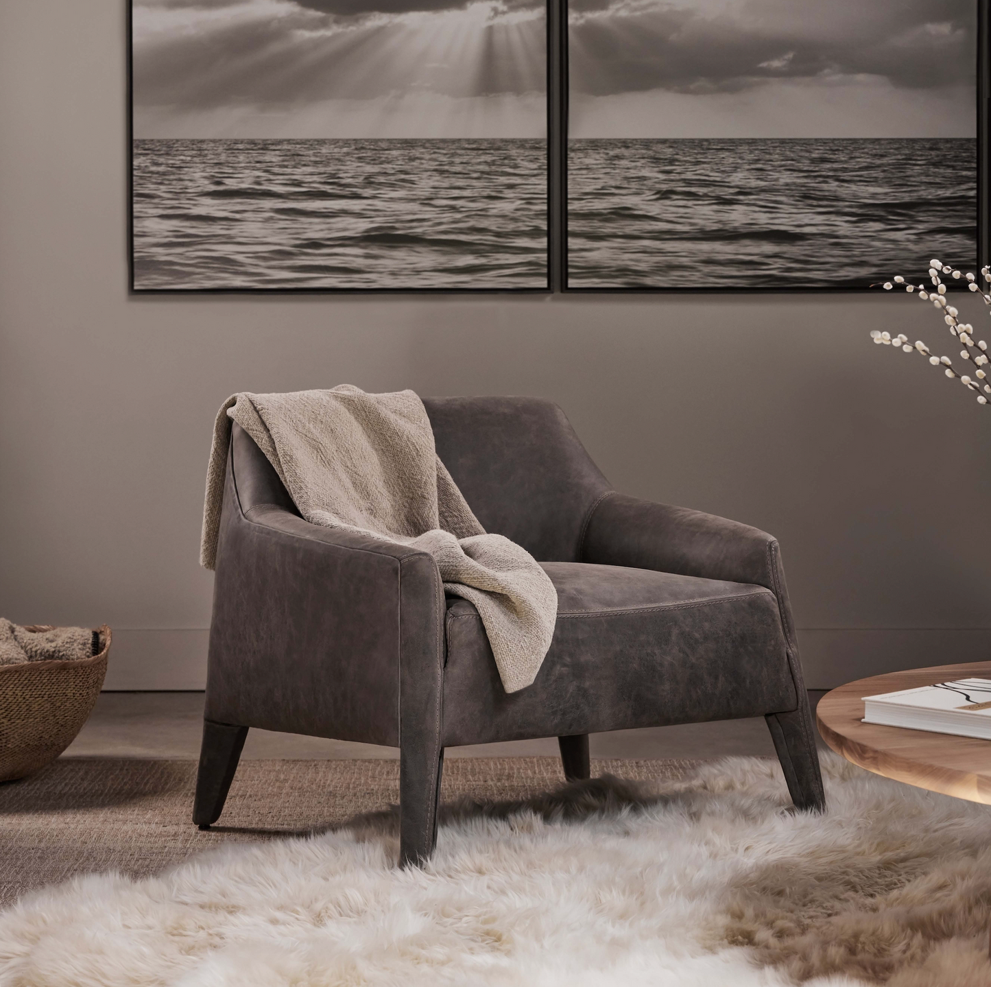 Custom order murphy chair gray suede armchair with soft textured blanket draped over the back