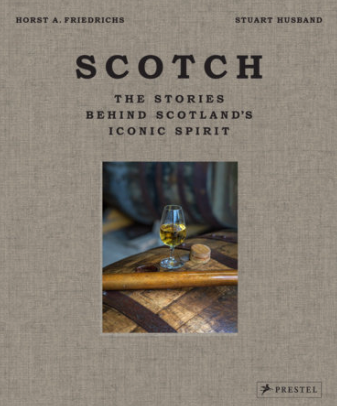 A clear glass whisky tumbler filled with golden scotch on a wooden surface beside a small cork for scotch stories