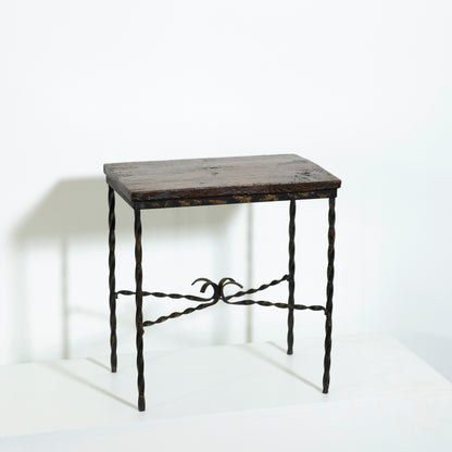 Small wooden table with wrought iron legs on a white background