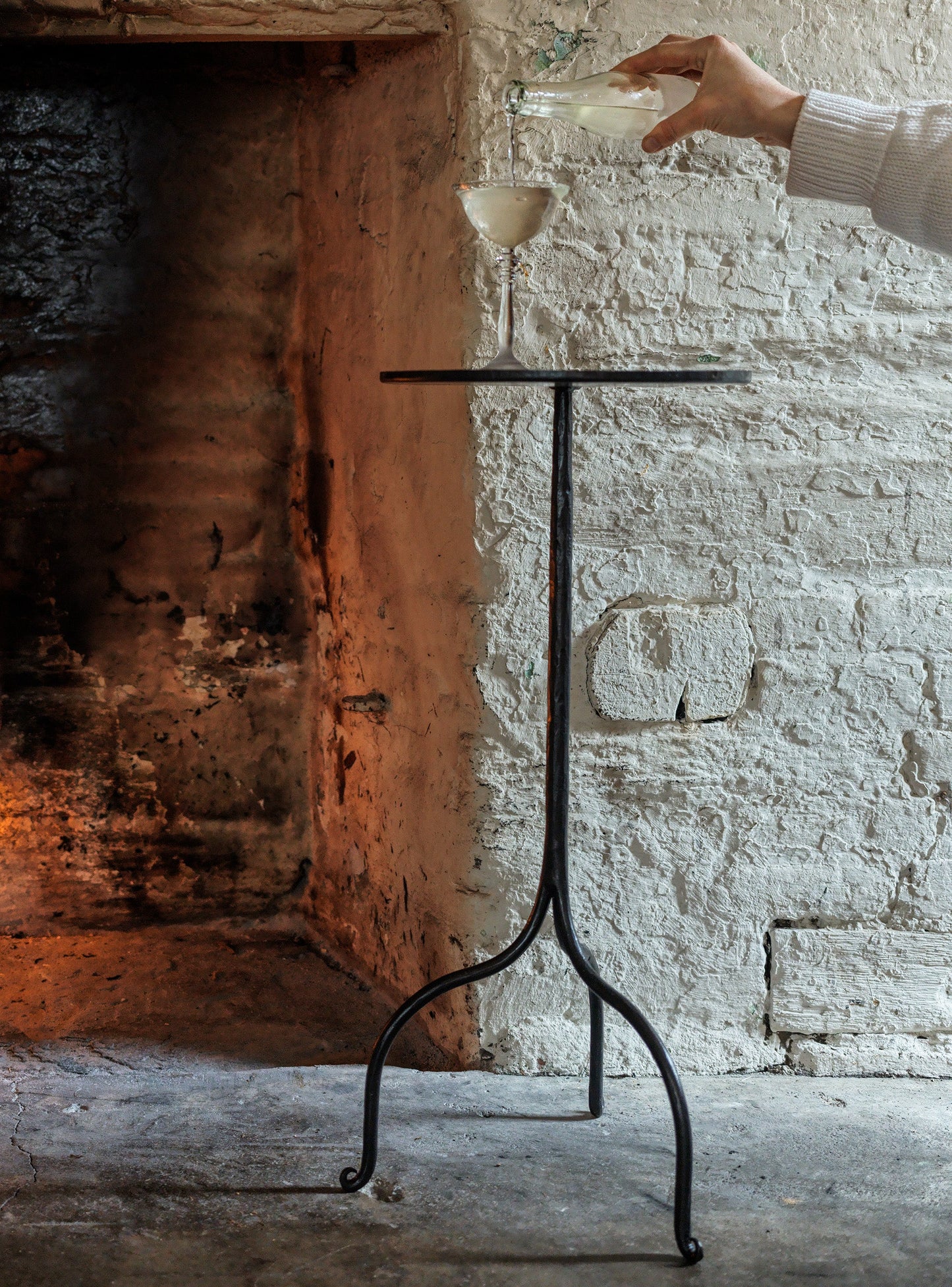 Black wrought iron side table with minimalist tripod base and flat top hand forged with optional leather insert