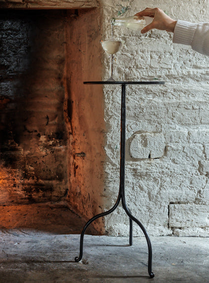 Black wrought iron side table with minimalist tripod base and flat top hand forged with optional leather insert