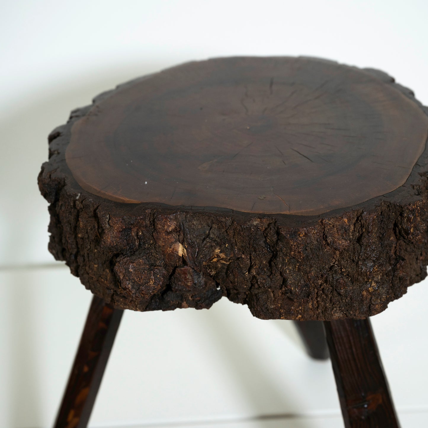 Wooden stool with a rustic design on a white background
