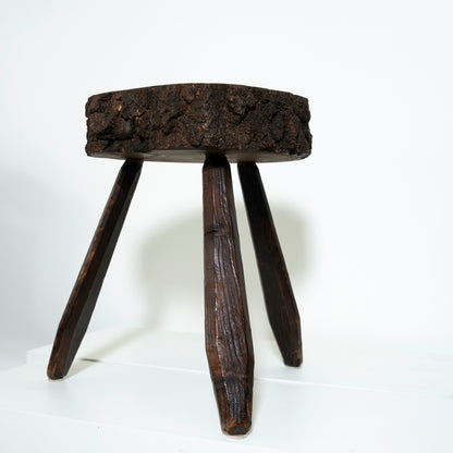 Wooden stool with a rustic design on a white background