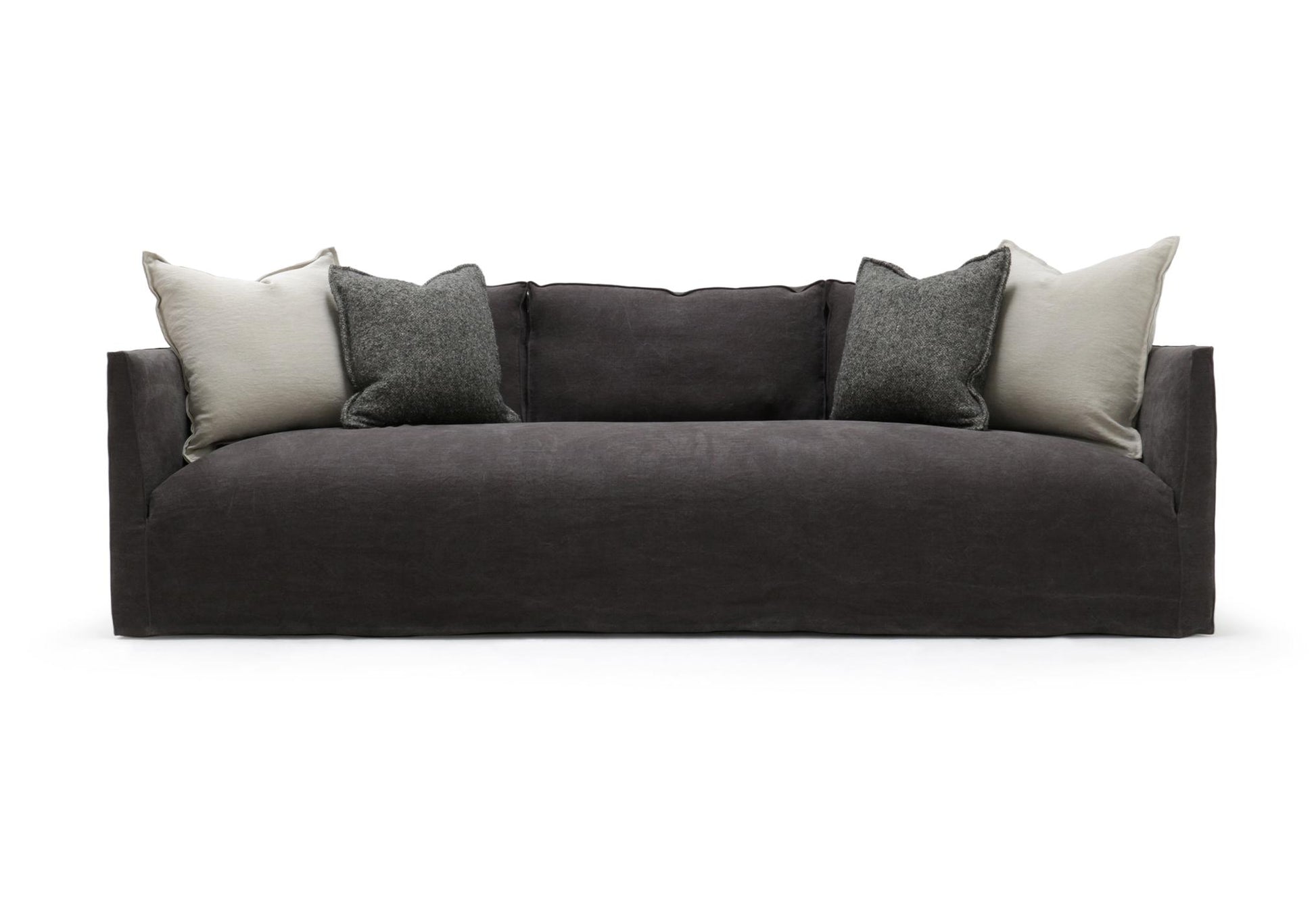 Dark gray upholstered Thibaut Flax Linen slipcovered sofa with modern design and light gray textured throw pillows 96 inches
