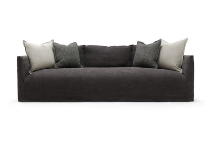 Dark gray upholstered Thibaut Flax Linen slipcovered sofa with modern design and light gray textured throw pillows 96 inches