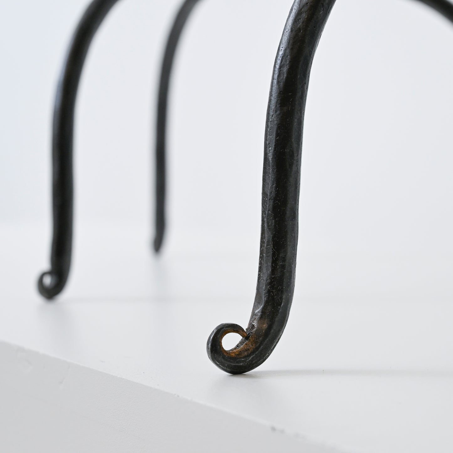 Black wrought iron hand forged iron side table with curved legs and rustic finish