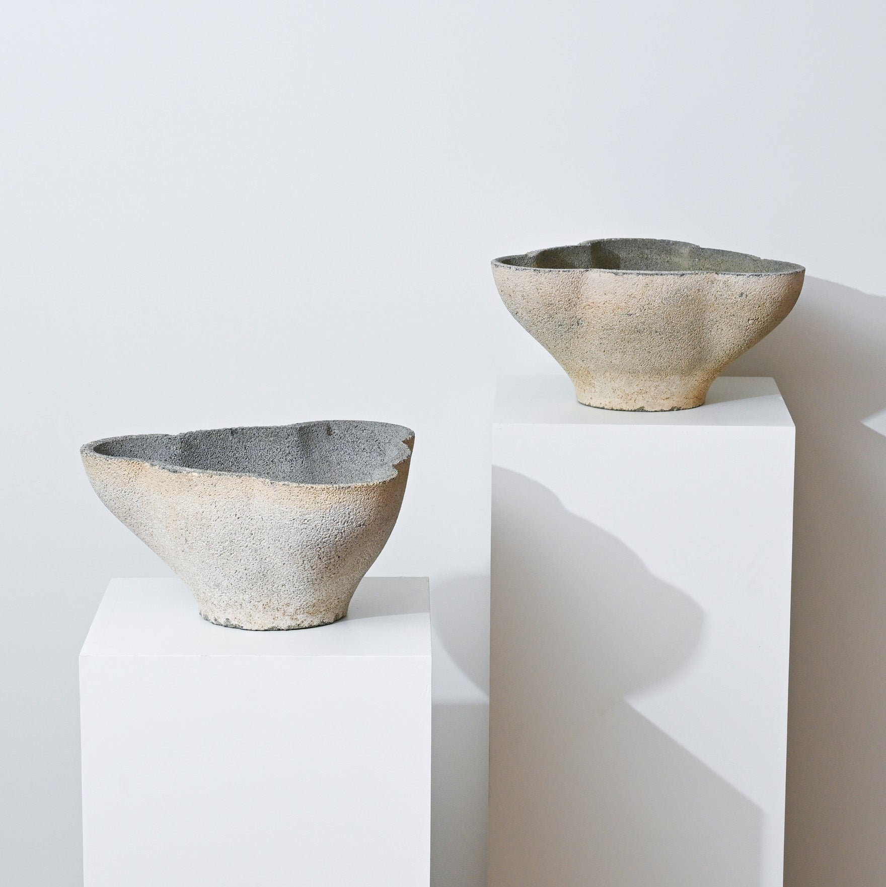 The 19th Century Antique Belgian Trefoil Planter, with its asymmetrical, textured ceramic design in muted earth tones, is displayed on a white pedestal against a plain white background for a minimalist modern look.