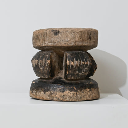 Hand carved indigenous West African stool dark brown wood with intricate carved patterns and rounded top