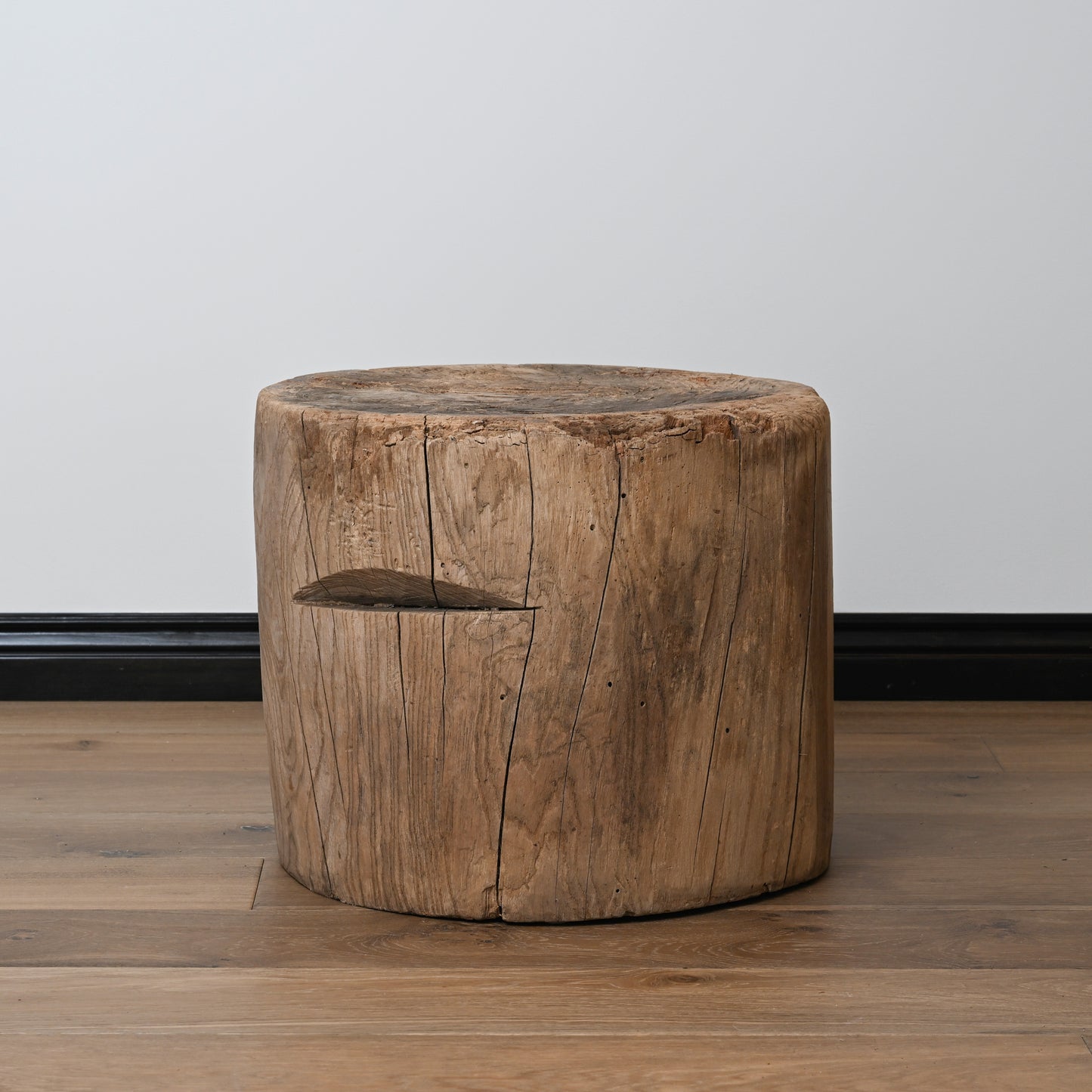 A late 19th century primitive japanese mortar usu table with a rustic cylindrical wooden stool and natural wood finish