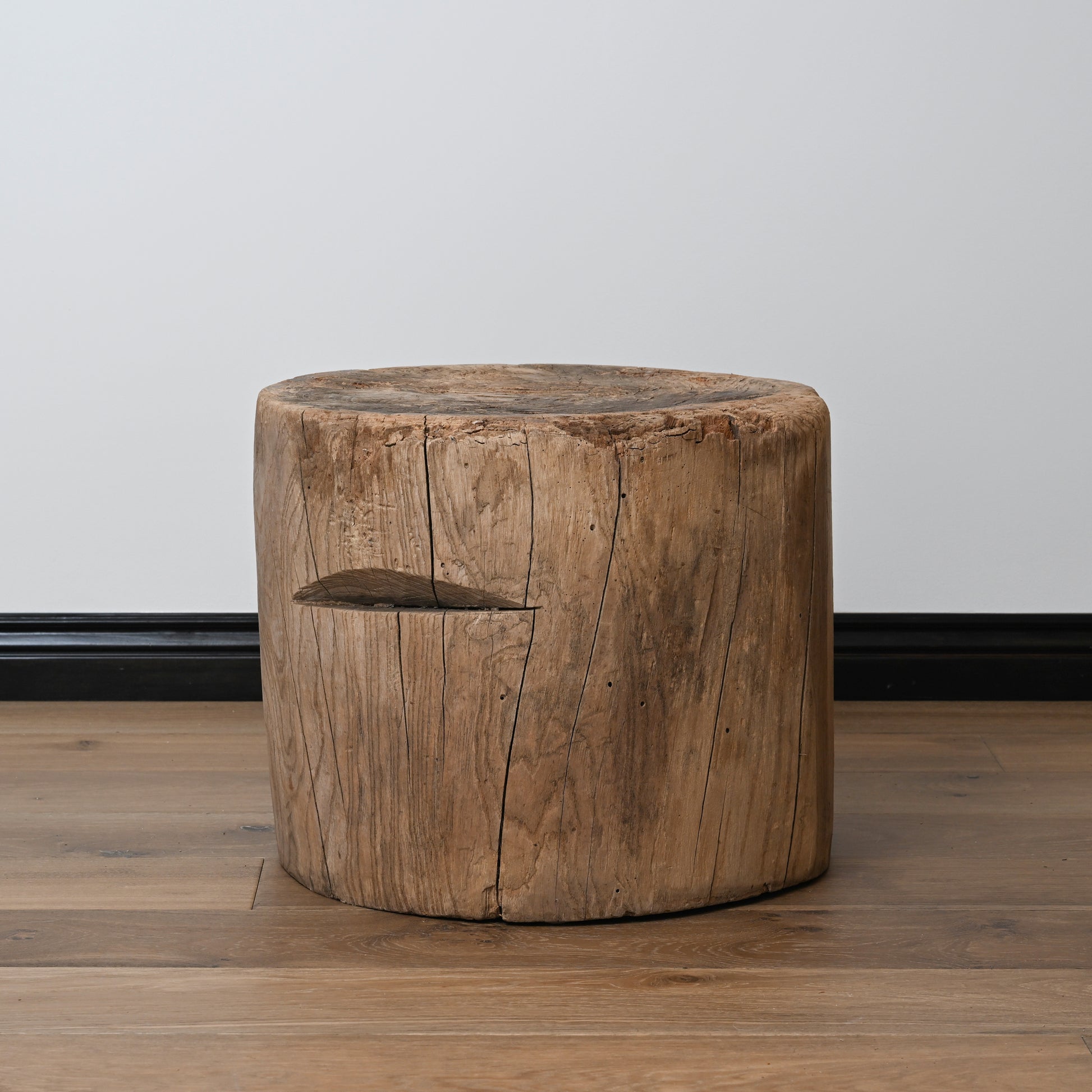 A late 19th century primitive japanese mortar usu table with a rustic cylindrical wooden stool and natural wood finish