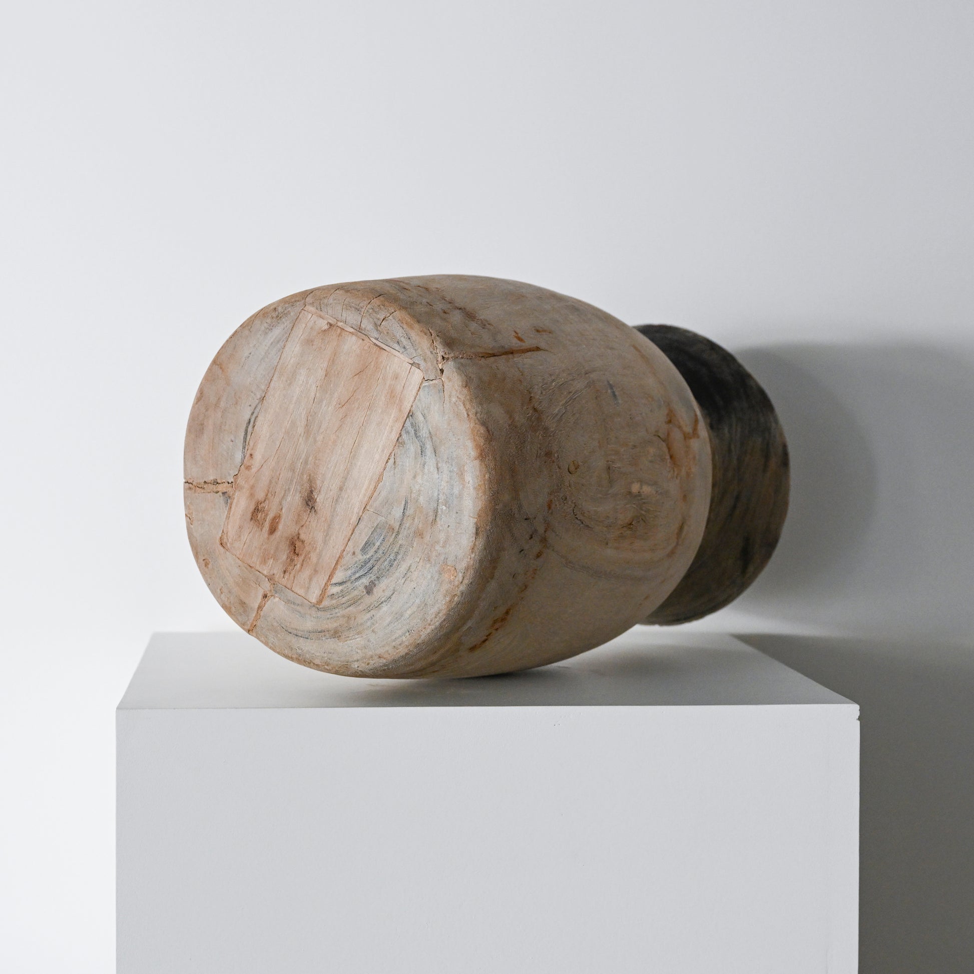 Handcrafted wooden primitive wood vessel with natural weathered finish and visible grain patterns in brown tones
