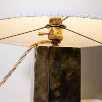 Brass and parchment table lamp with a rectangular brass base in dark patinated finish and textured surface