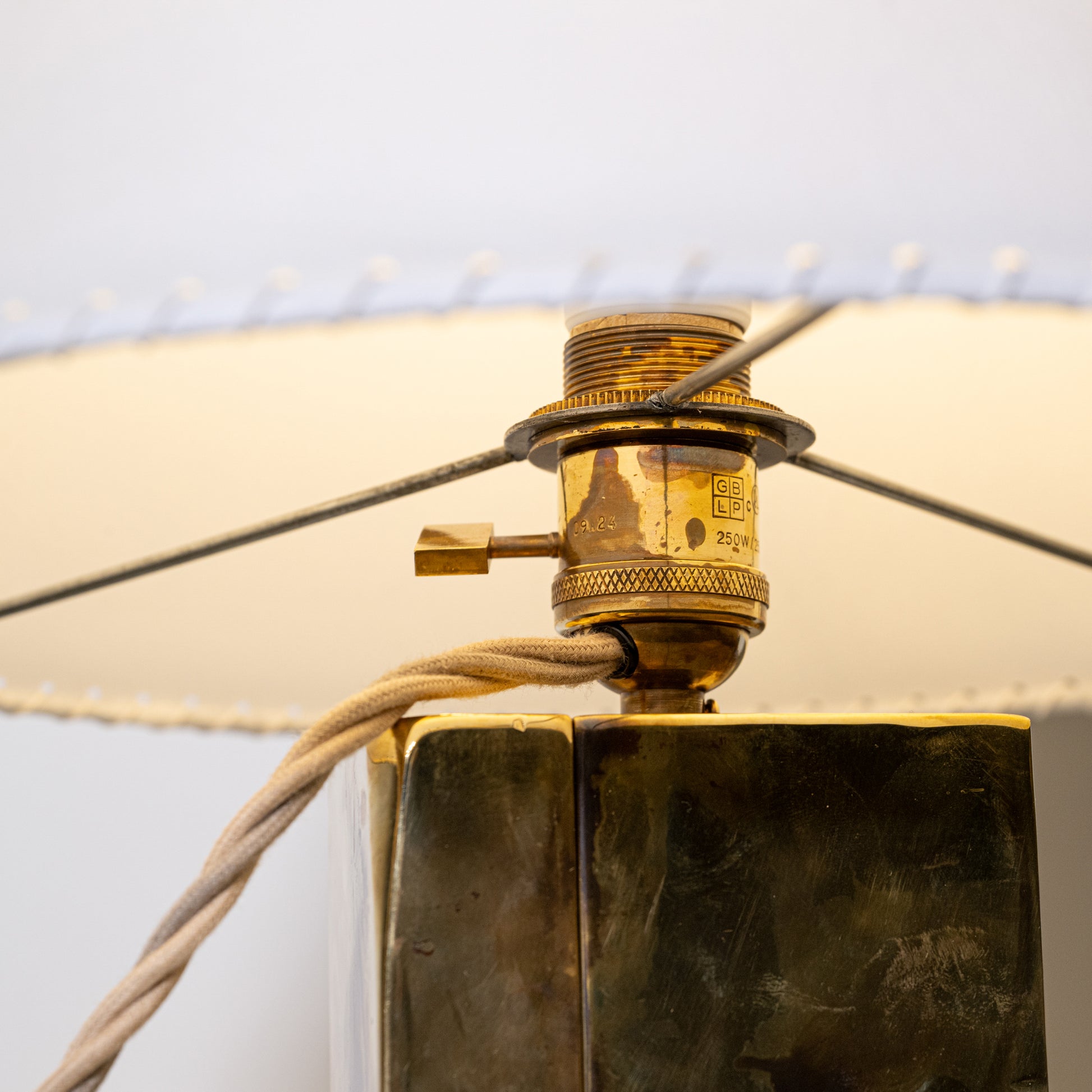 Golden brass and parchment table lamp with textured tarnished brass base engraved gb lp visible on the back side