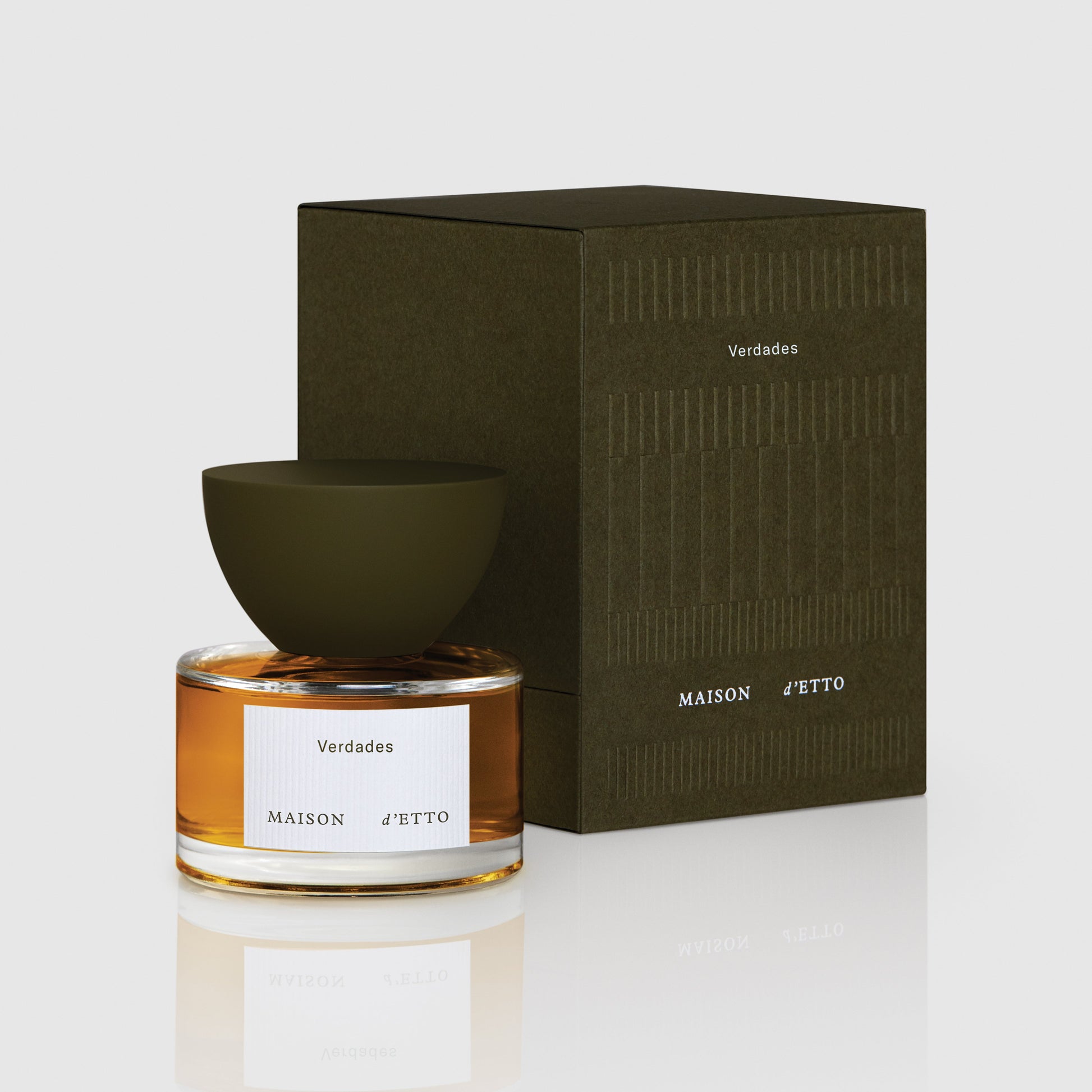 Maison d’Etto fragrance Verdades perfume in a clear glass bottle with olive green cap and matching dark green packaging