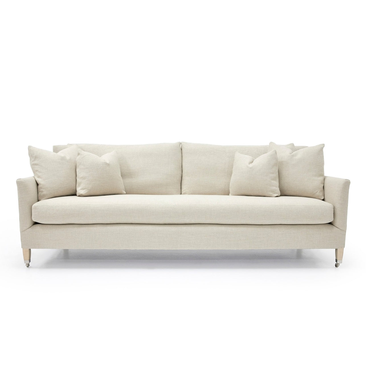 Beige upholstered custom order victor sofa with clean lines and matching throw pillows for modern living rooms