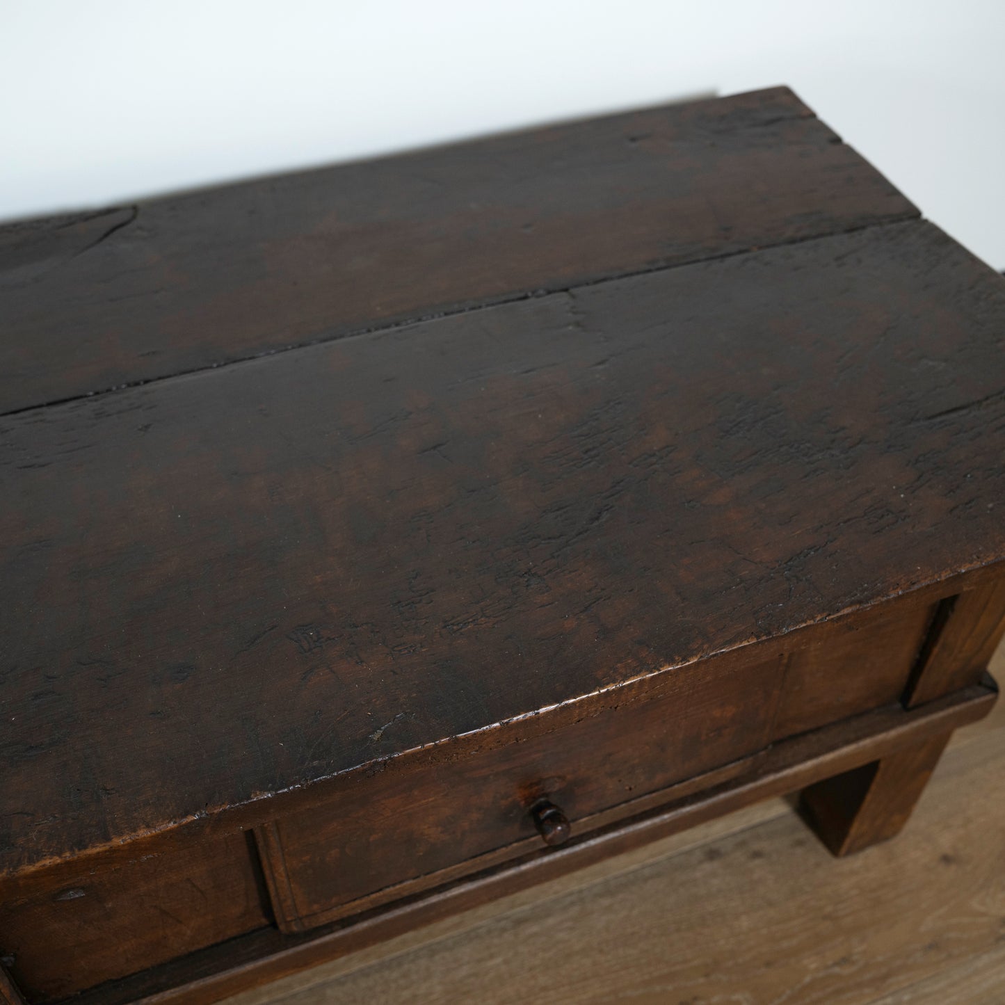 Wooden crate with a dark brown top and lighter sides on a white background