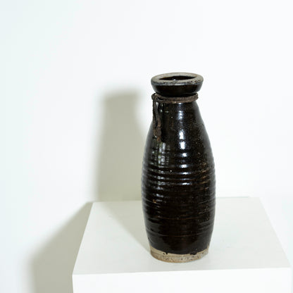 Black ceramic vase on a white background