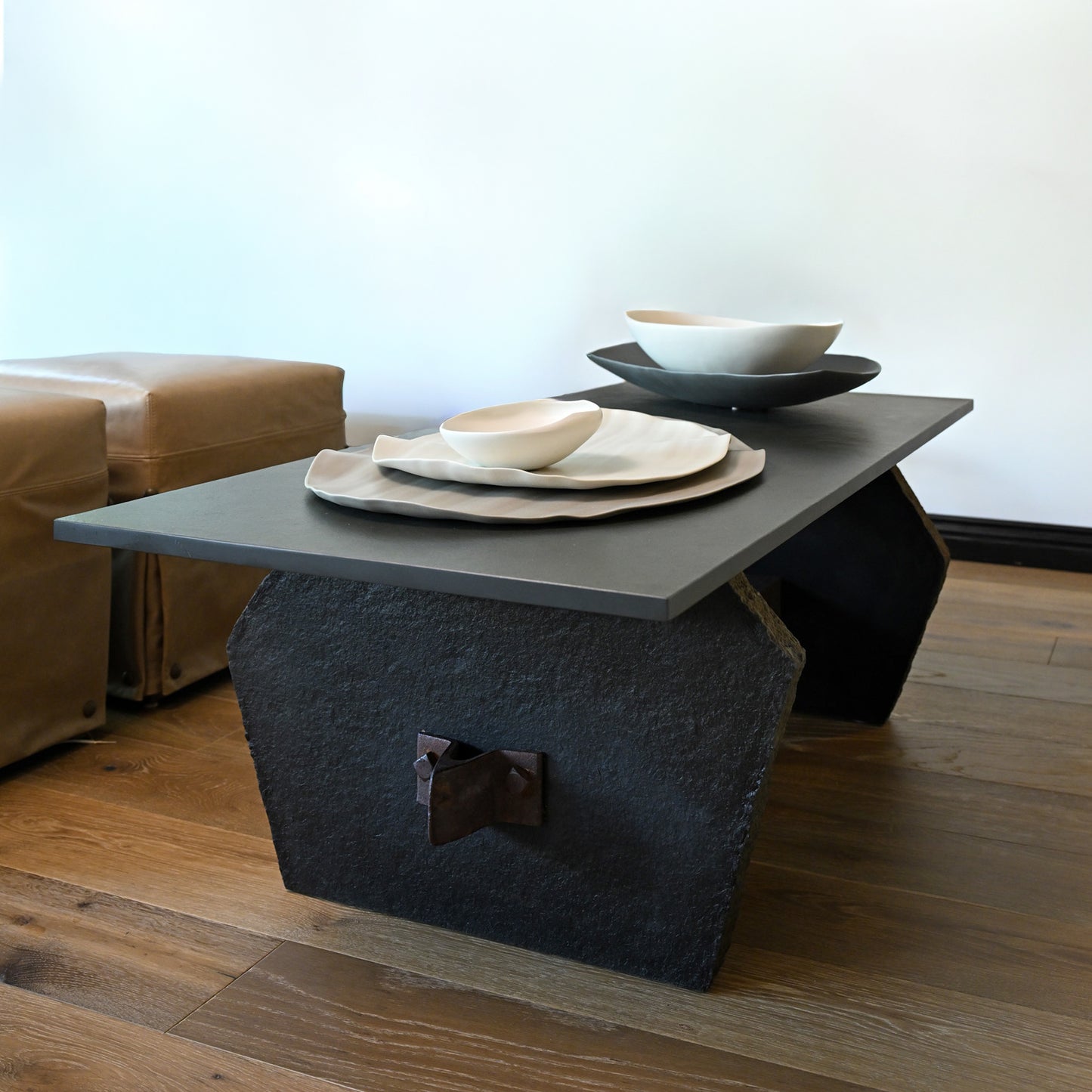 Dark gray stone blue stone cocktail table with a textured angular base and sleek rectangular top for living rooms