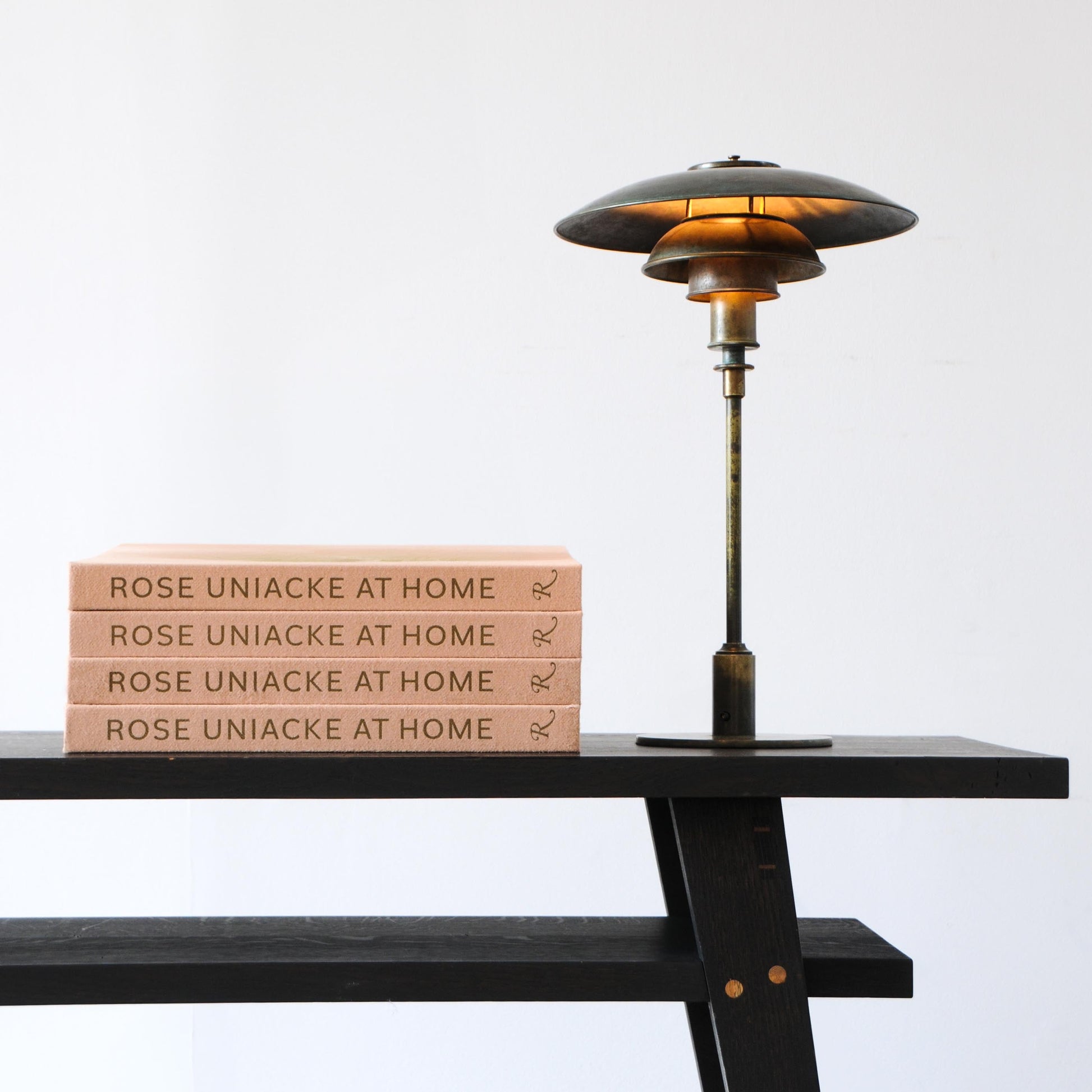 A sleek dark bronze poul henningsen ph 5 lamp with tiered disc shade and warm amber glow in rose uniacke at home